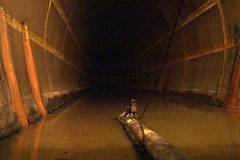 View inside adjoining tank showing running groundwater and oil pickup pipework